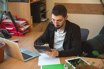 Image showing Caucasian entrepreneur, businessman, manager working concentrated in office