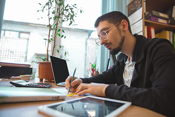 Image showing Caucasian entrepreneur, businessman, manager working concentrated in office