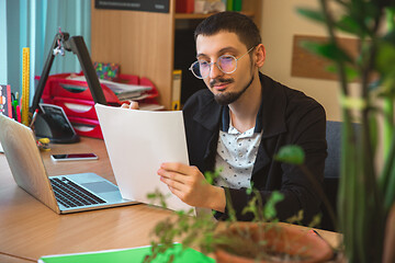 Image showing Caucasian entrepreneur, businessman, manager working concentrated in office