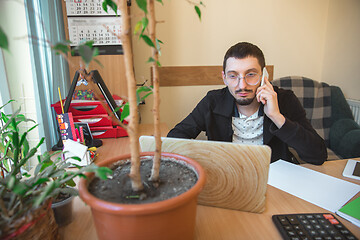 Image showing Caucasian entrepreneur, businessman, manager working concentrated in office