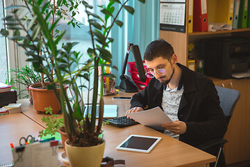 Image showing Caucasian entrepreneur, businessman, manager working concentrated in office