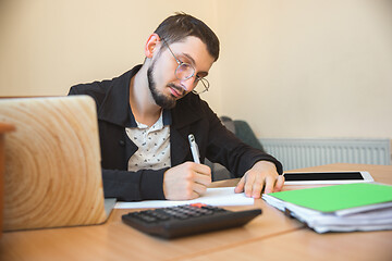 Image showing Caucasian entrepreneur, businessman, manager working concentrated in office