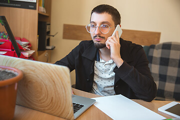 Image showing Caucasian entrepreneur, businessman, manager working concentrated in office