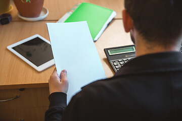 Image showing Caucasian entrepreneur, businessman, manager working concentrated in office