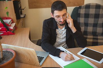 Image showing Caucasian entrepreneur, businessman, manager working concentrated in office