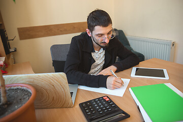 Image showing Caucasian entrepreneur, businessman, manager working concentrated in office