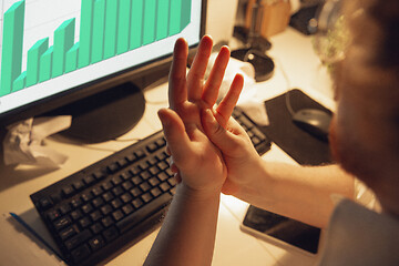 Image showing Man working in office alone during coronavirus or COVID-19 quarantine, staying to late night