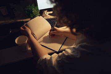 Image showing Man working in office alone during coronavirus or COVID-19 quarantine, staying to late night