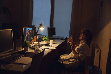 Image showing Man working in office alone during coronavirus or COVID-19 quarantine, staying to late night