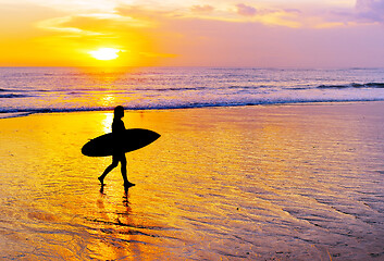 Image showing Woman surfing on tropical island