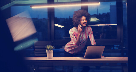 Image showing black businesswoman using a laptop in night startup office