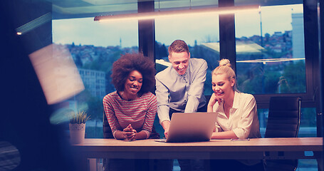 Image showing Multiethnic startup business team in night office