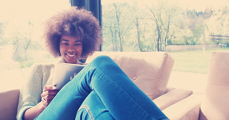 Image showing african american woman at home using digital tablet