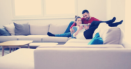 Image showing couple relaxing at  home with tablet computers