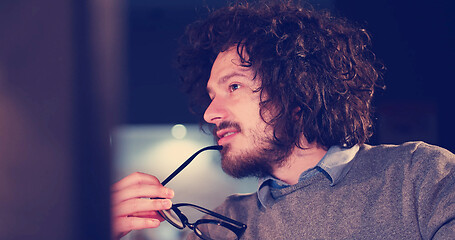 Image showing man working on computer in dark office