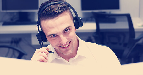 Image showing male call centre operator doing his job