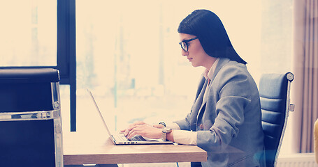 Image showing businesswoman using a laptop in startup office