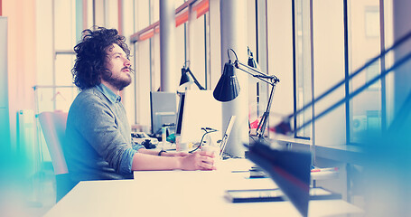 Image showing businessman working using a laptop in startup office