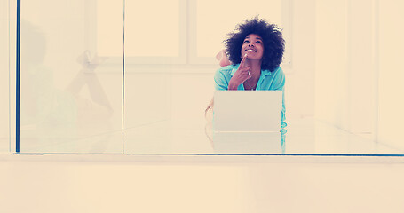 Image showing black women using laptop computer on the floor