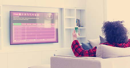 Image showing Young couple on the sofa watching television