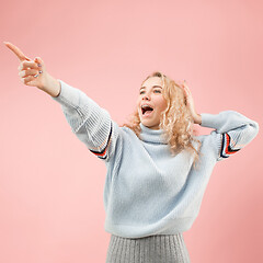 Image showing Beautiful woman looking suprised isolated on pink