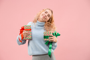 Image showing Woman with big beautiful smile holding colorful gift boxes.