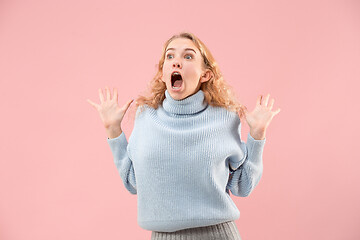 Image showing Beautiful woman looking suprised isolated on pink