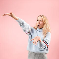 Image showing Beautiful woman looking suprised isolated on pink