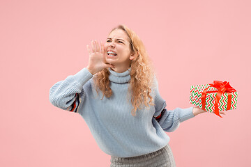 Image showing Woman with big beautiful smile holding colorful gift box.