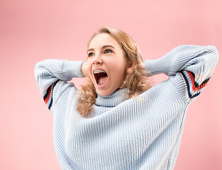 Image showing Beautiful woman looking suprised isolated on pink