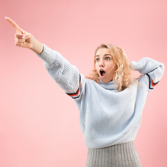 Image showing Beautiful woman looking suprised isolated on pink