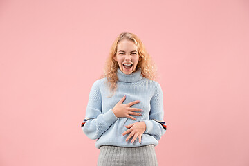 Image showing The happy business woman standing and smiling against pink background.