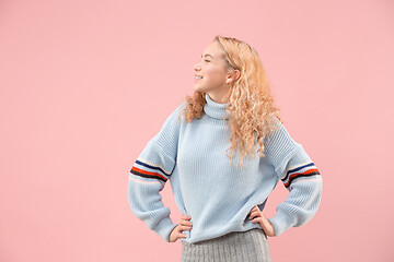 Image showing The happy business woman standing and smiling against pink background.