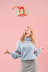 Image showing Woman with big beautiful smile holding colorful gift box.