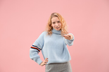 Image showing The happy business woman point you and want you, half length closeup portrait on pink background.