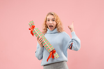 Image showing Woman with big beautiful smile holding colorful gift box.