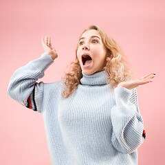 Image showing Beautiful woman looking suprised isolated on pink