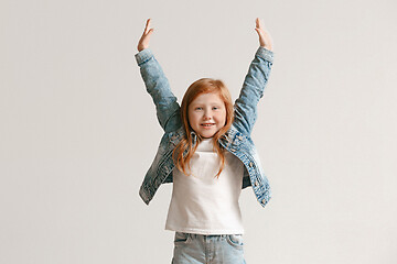 Image showing Full length portrait of cute little kid in stylish jeans clothes looking at camera and smiling