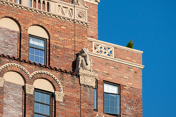 Image showing red brick building detail with stone figure in New York City