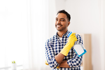 Image showing smiling indian man with detergent cleaning at home