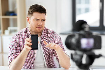 Image showing male vlogger with smartphone videoblogging at home