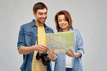 Image showing happy couple of tourists with map and camera