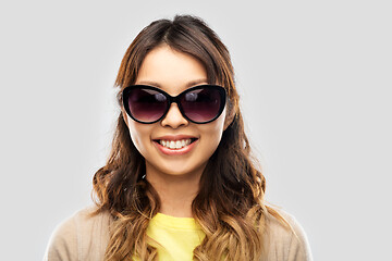 Image showing happy smiling young asian woman in sunglasses