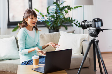 Image showing asian female blogger with camera recording video