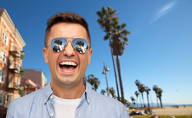 Image showing laughing man in sunglasses over venice beach