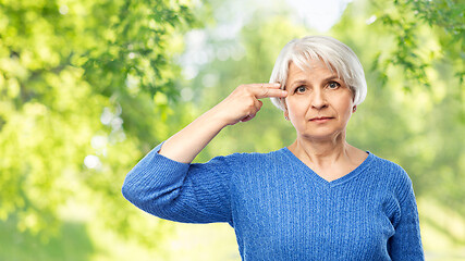 Image showing senior woman making finger gun gesture