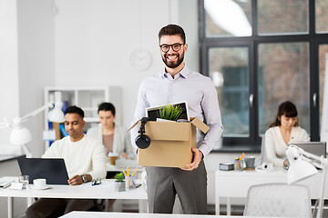 Image showing happy male office worker with personal stuff
