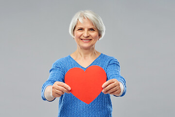 Image showing smiling senior woman with red heart