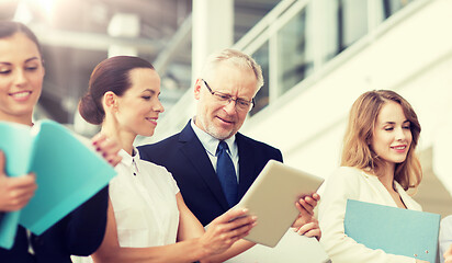 Image showing business team with tablet pc and folders at office