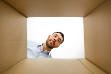 Image showing man looking into open parcel box